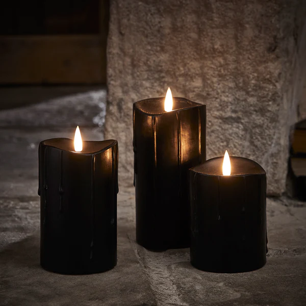 three realistic black battery powered candles